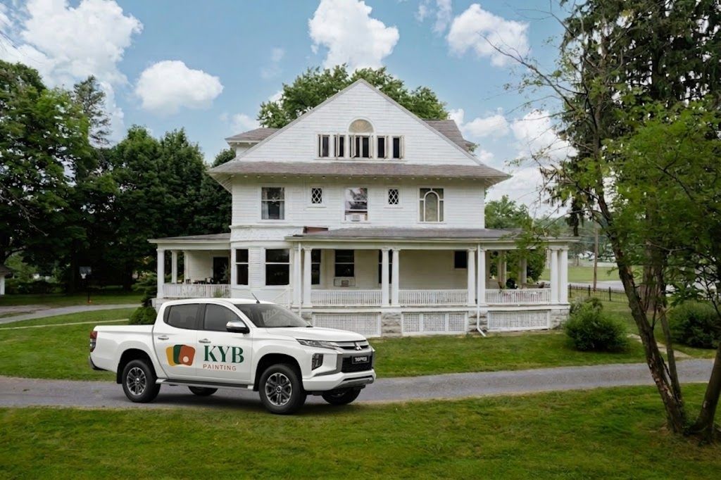 KYB Painting ute parked in front of a large Melbourne weatherboard home